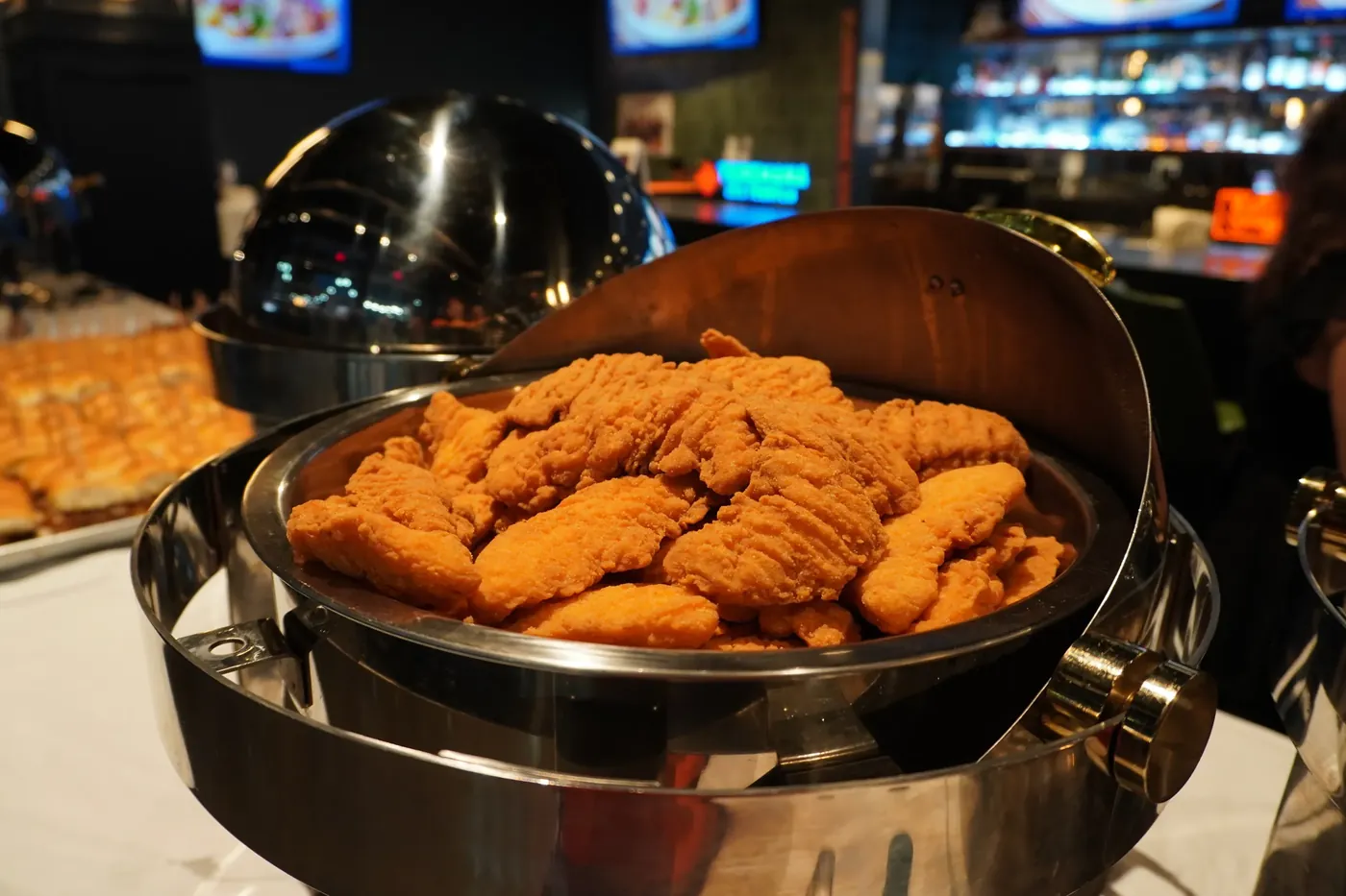 Chicken tenders in a chafer on the catering line at Bunkers