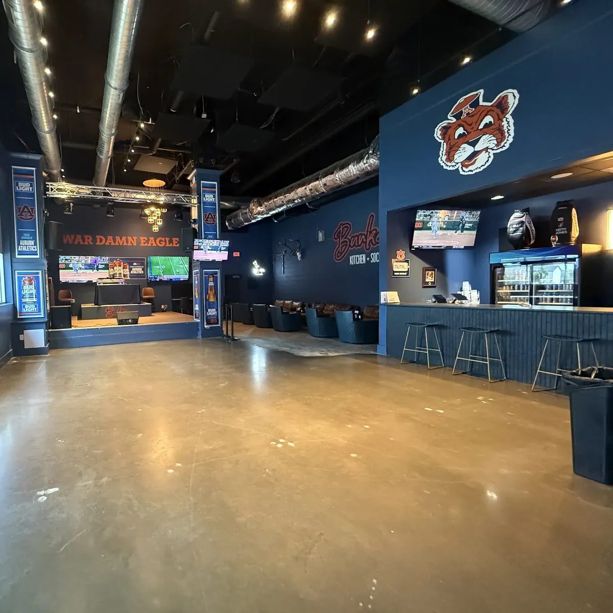 The Bunkers stage under WAR DAMN EAGLE, with the bar and its stools along the right wall